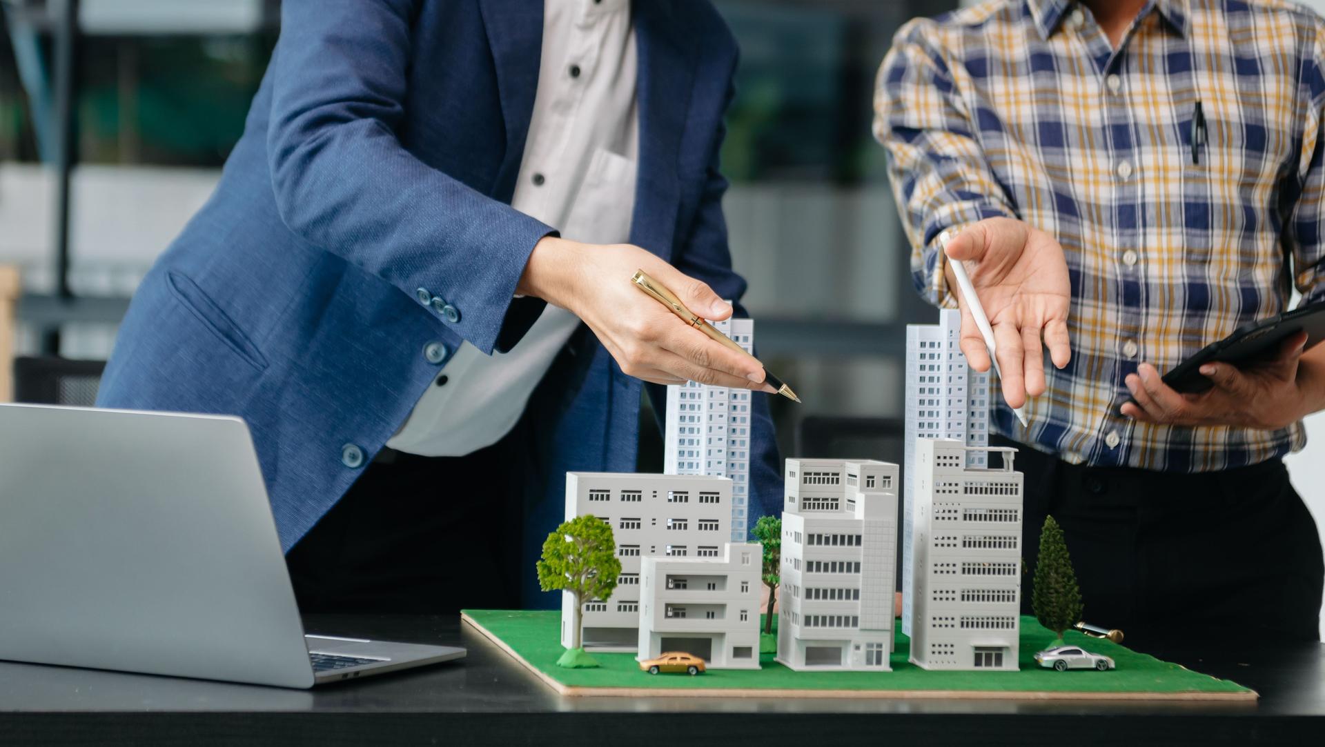 balancing the property sector The real estate agent is explaining the house style to see the house design and the purchase agreement. house city